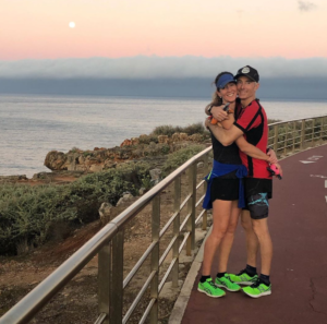 Happy Runner couple by the sea