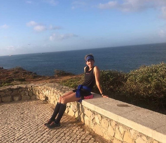 Trail runner relaxing by the ocean